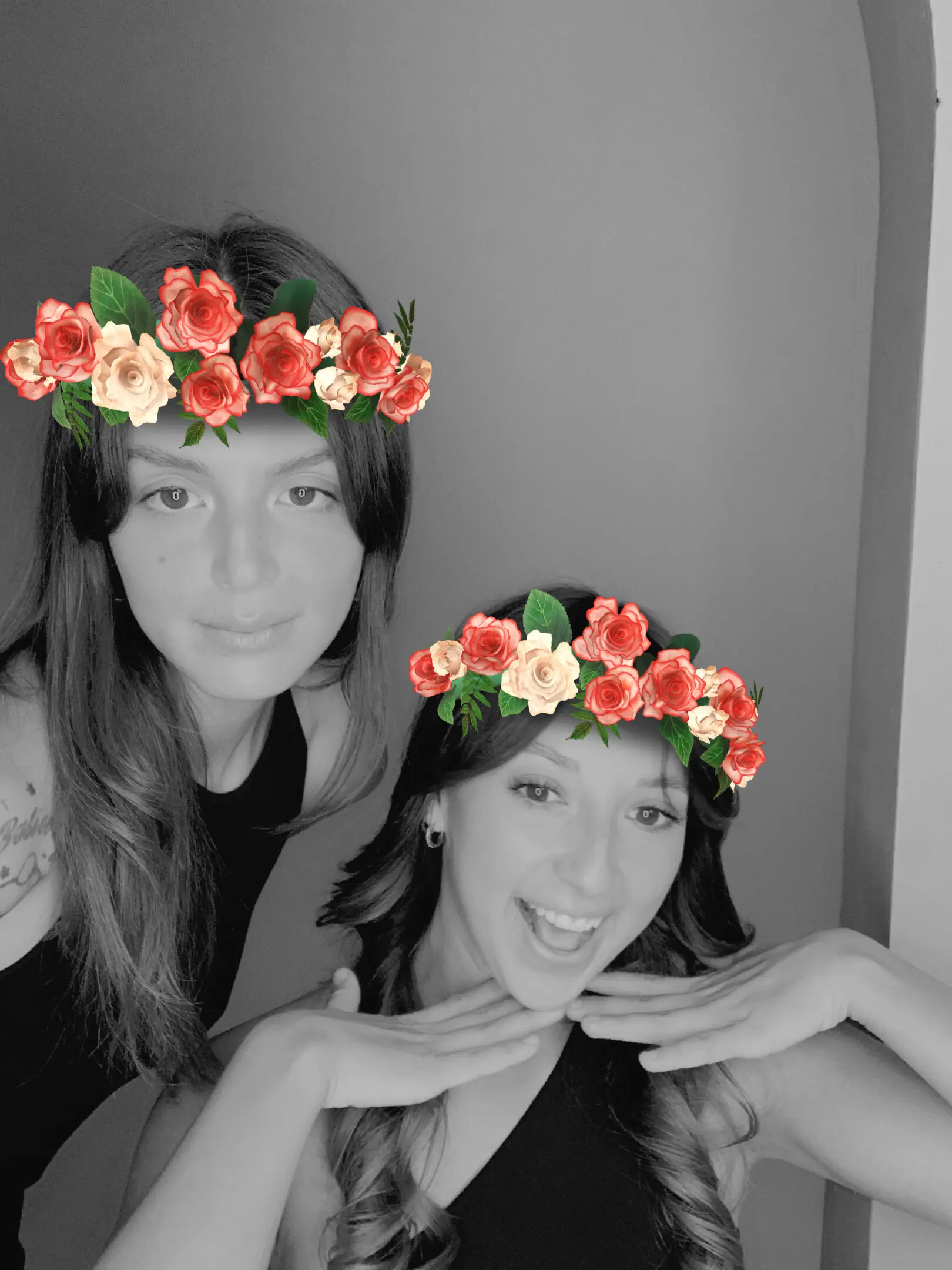 Two women with flower crowns smiling.